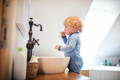 Toddler brushing teeth.