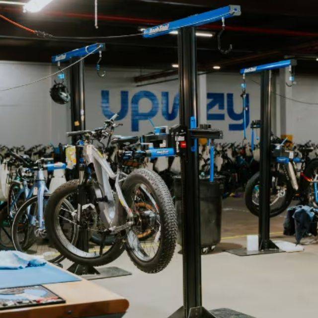 E-bikes on stands in the upway workshop