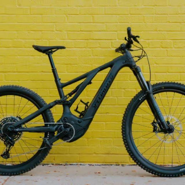 Specialized Turbo Levo in front of yellow wall
