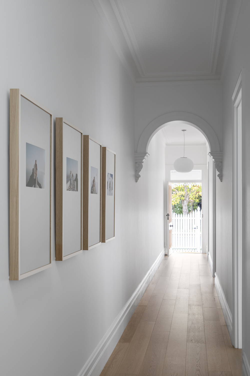 Gallery Wall of Framed Photography in a beautiful hallway