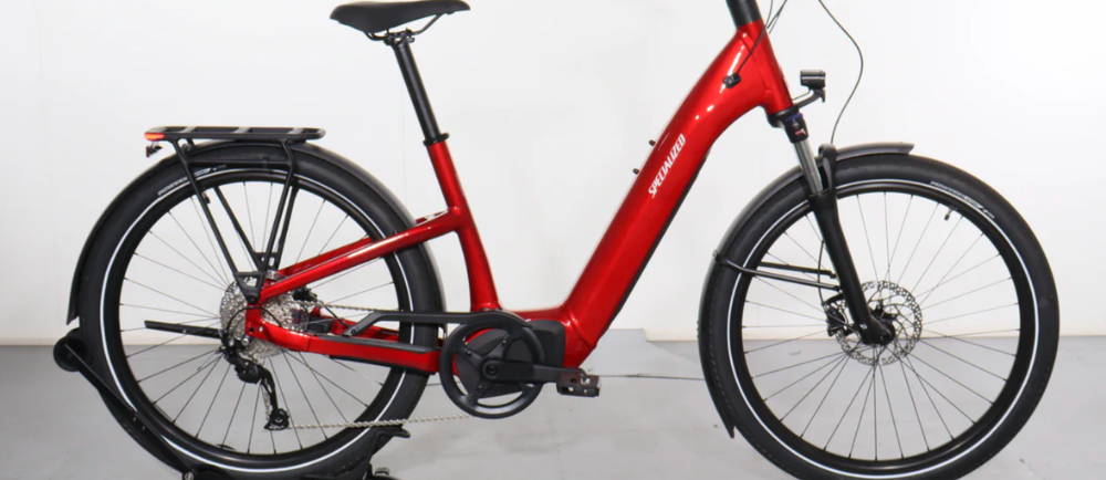 a red Specialized Turbo Como 3.0 electric city bike