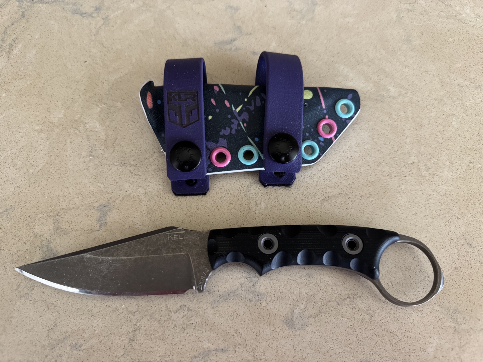 This is a photo of the blem Nightstalker I ordered. I cut the edge in and sharpened it myself, then ordered a custom KLR Holsters sheath. Makes a wonderful EDC gift for my lady! – by Travis