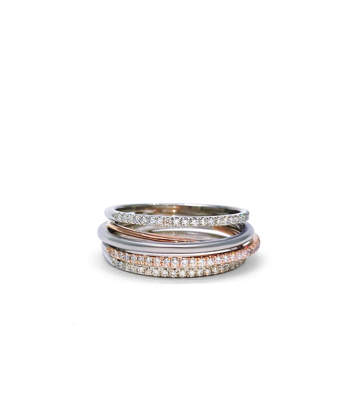 Multiple interlocking rings in pink and white gold paved with small diamonds.