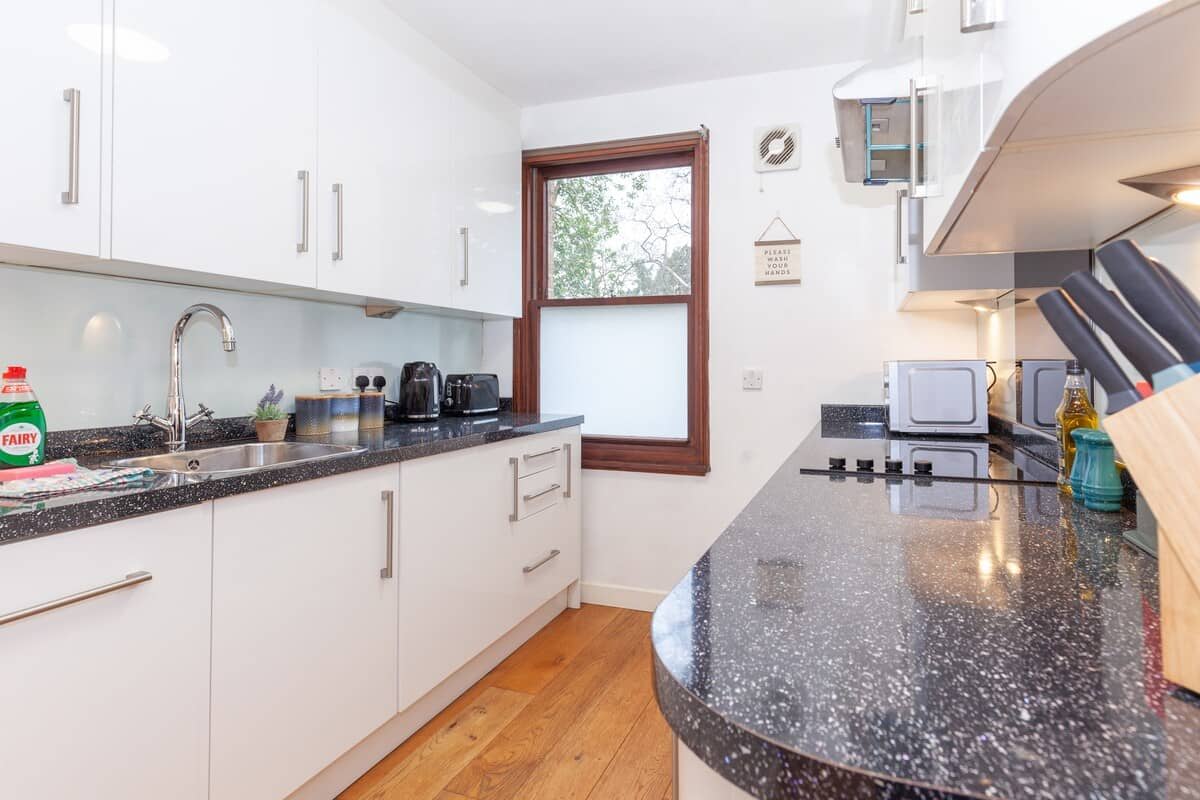 Kitchen showing marble tops and white cabinets