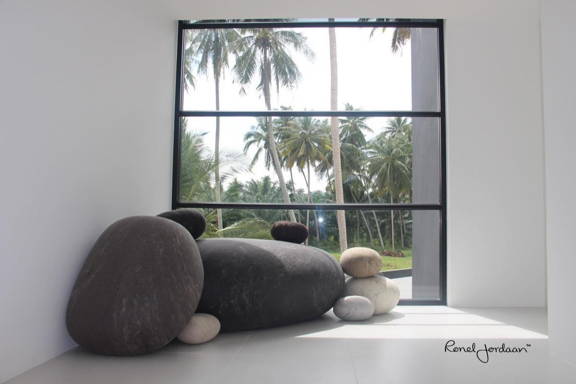 Several Ronel Jordaan Textile stones in front of a window