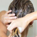 back of woman's hair being washed