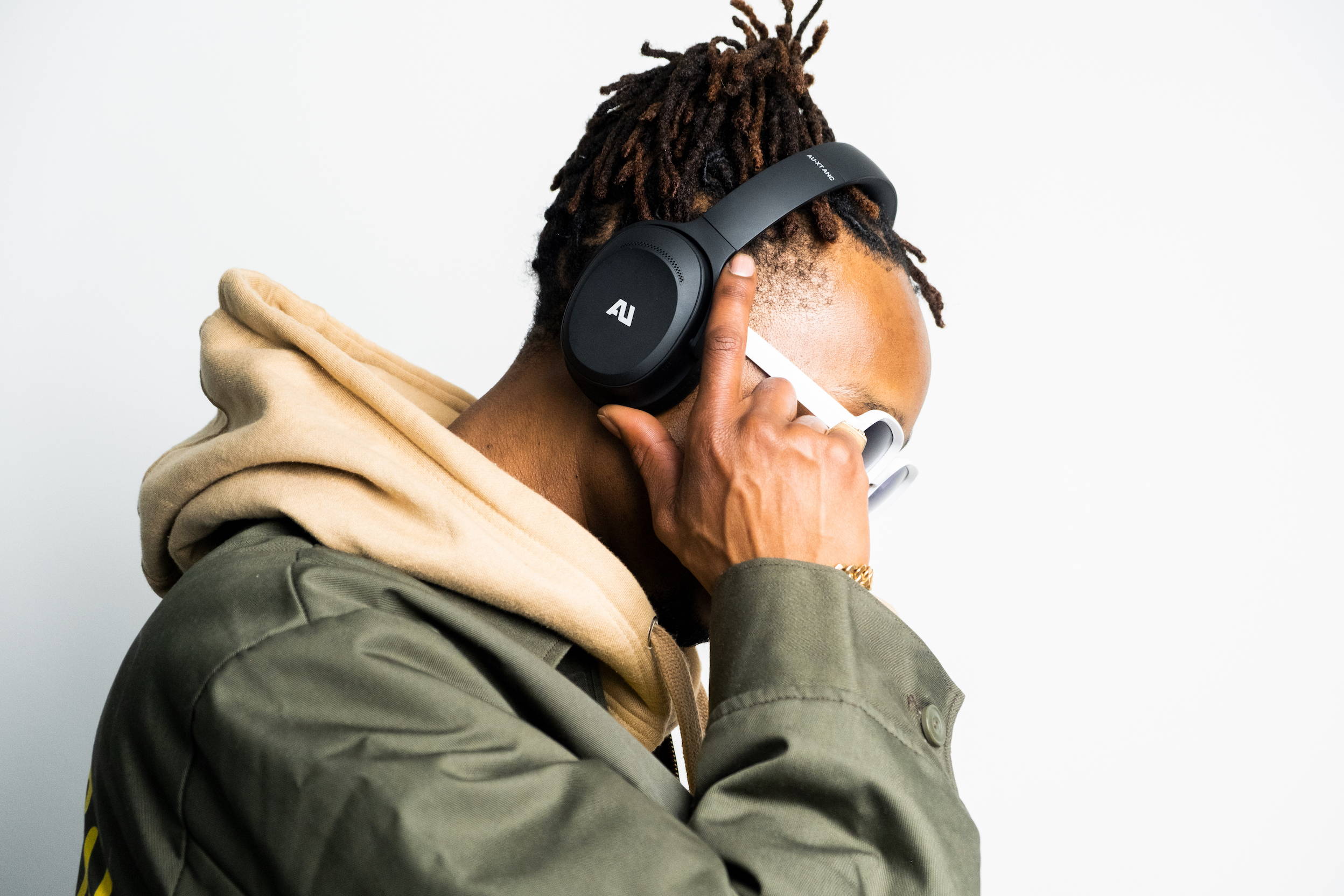 Marty Grimes wearing Ausounds noise-canceling headphone