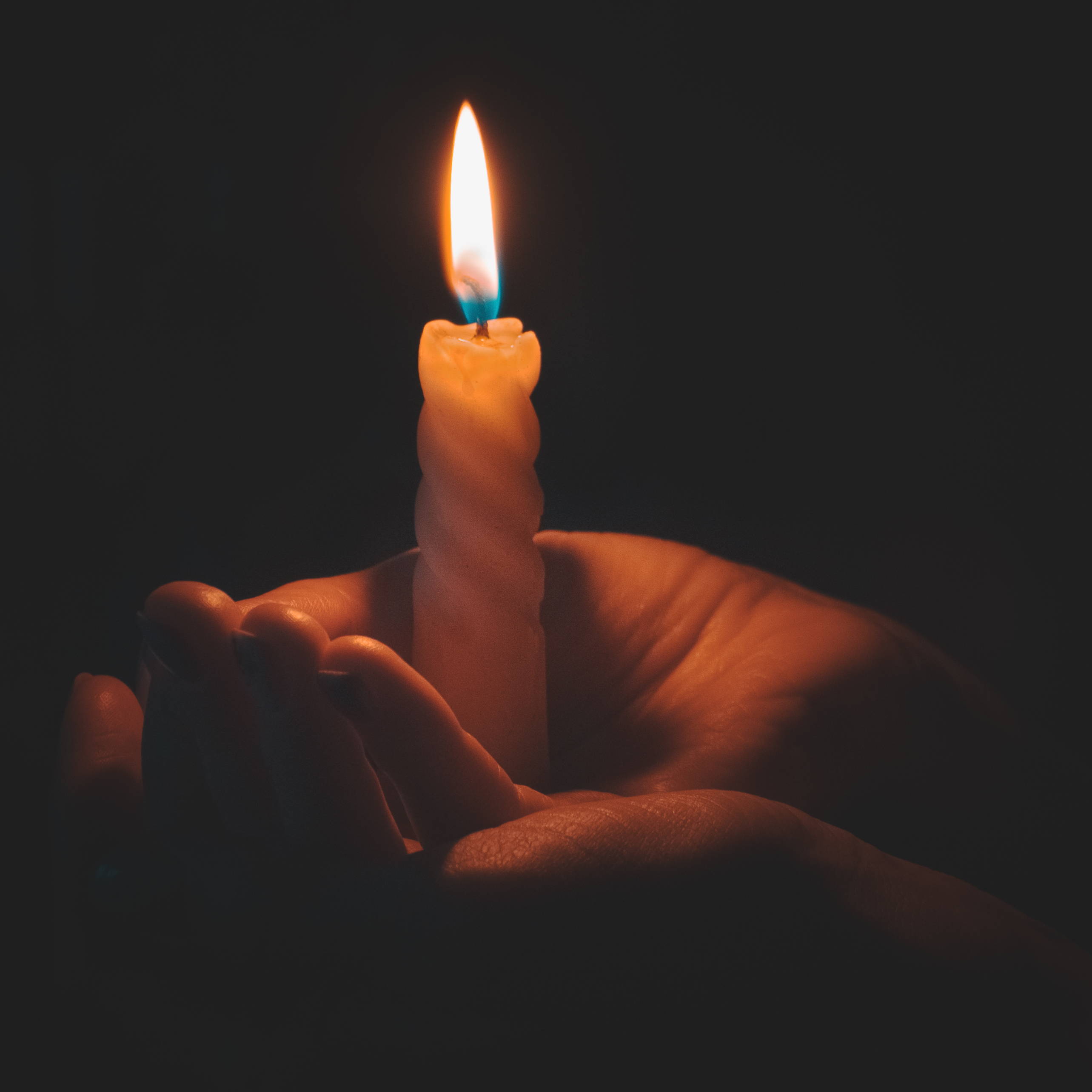 Male hands holding candle