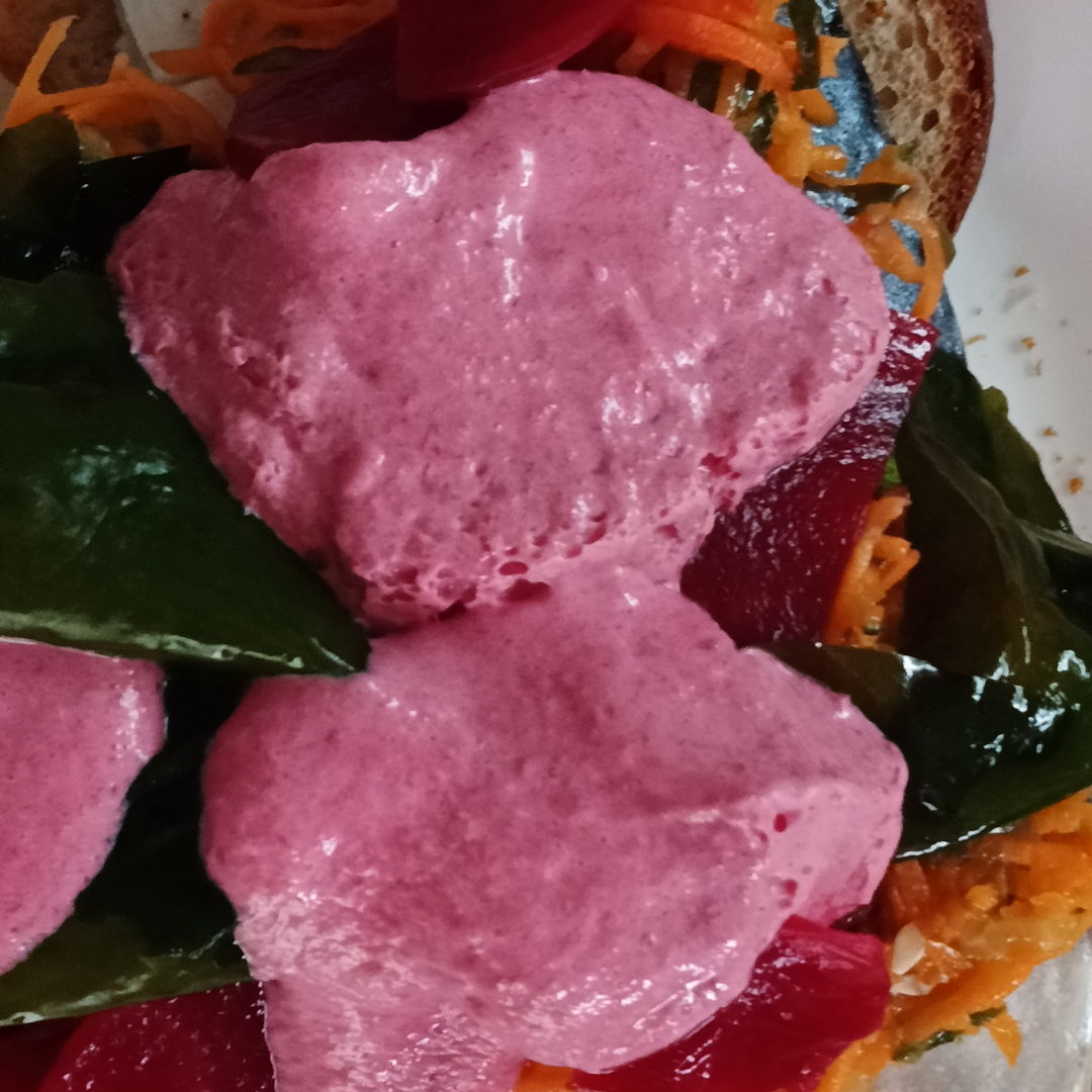 Marinated herring, red beets, red beets puree, salad on buttered dark bread