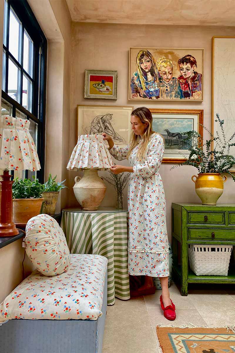 Alice Palmer wears YOLKE's Blossom Print Ophelia Dress to match her lampshades