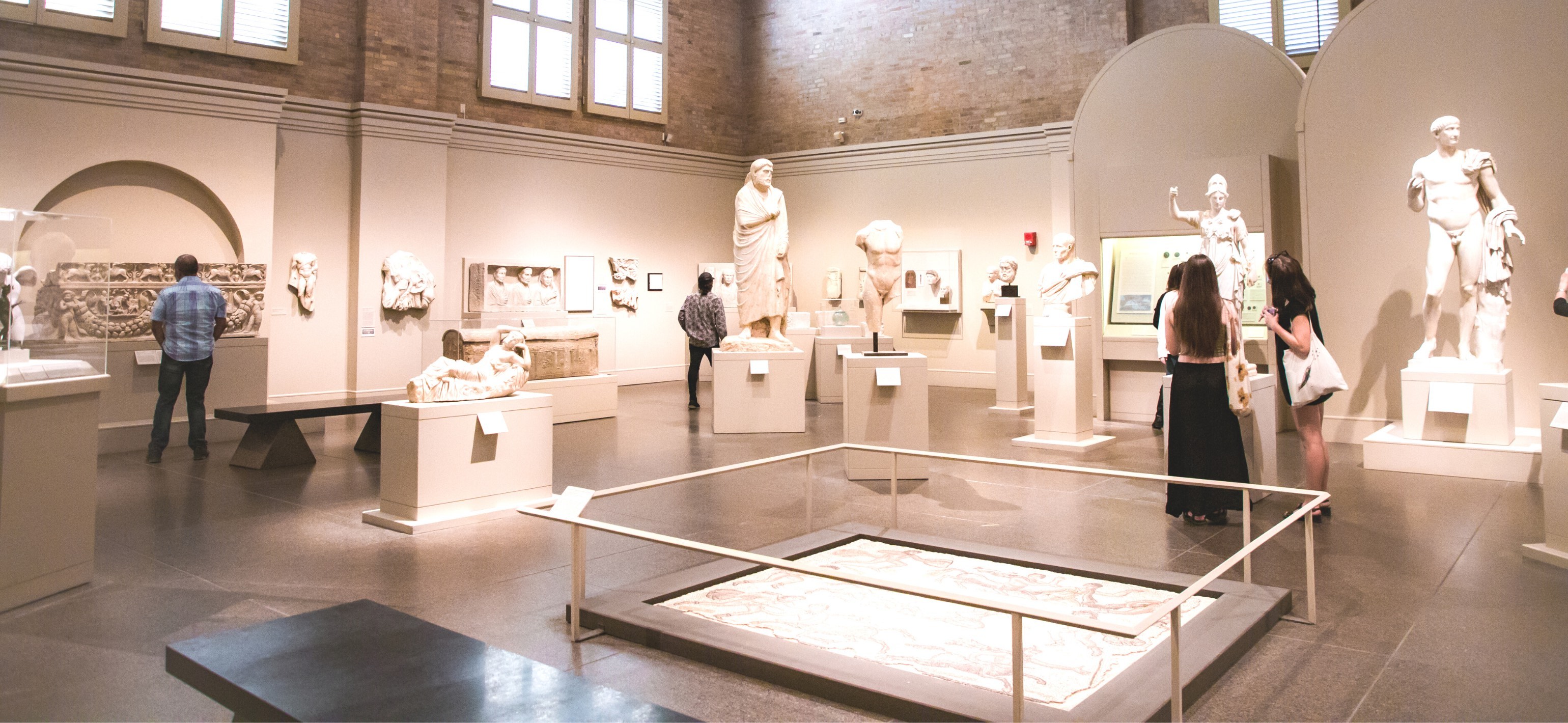 roman and greek statue gallery with people