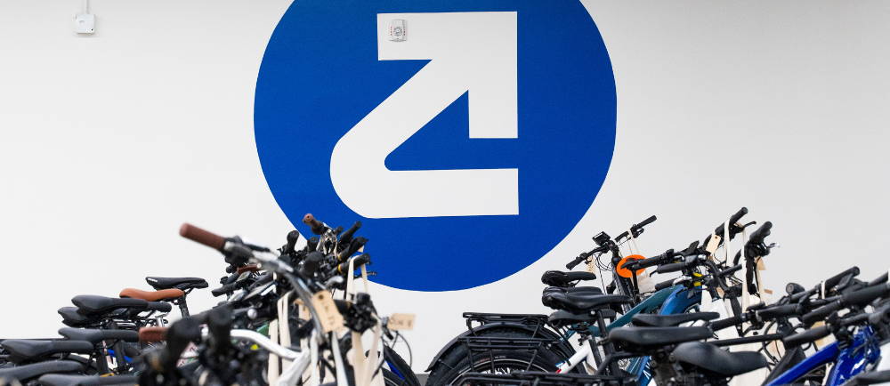 Upway logo in warehouse with bike cockpits