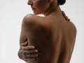 woman touching her damaged skin