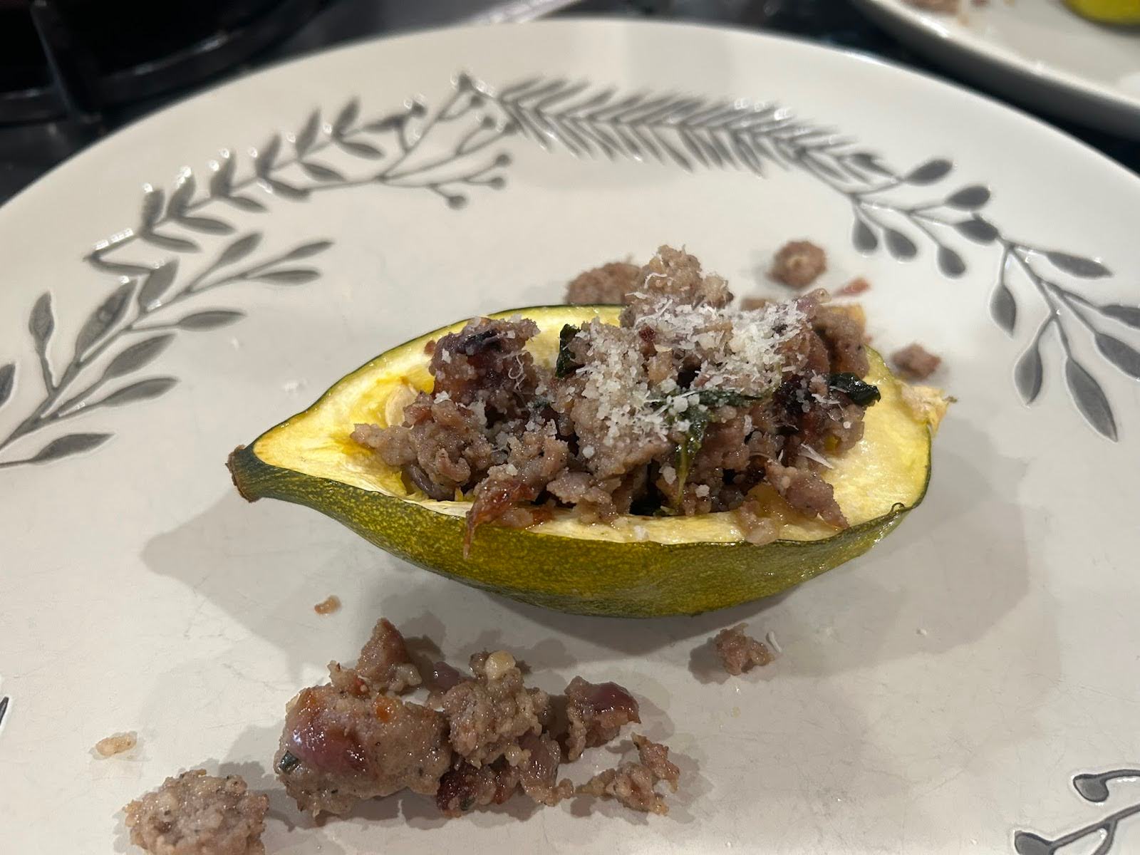 Squash boats with sausage and apples on a decorative plant