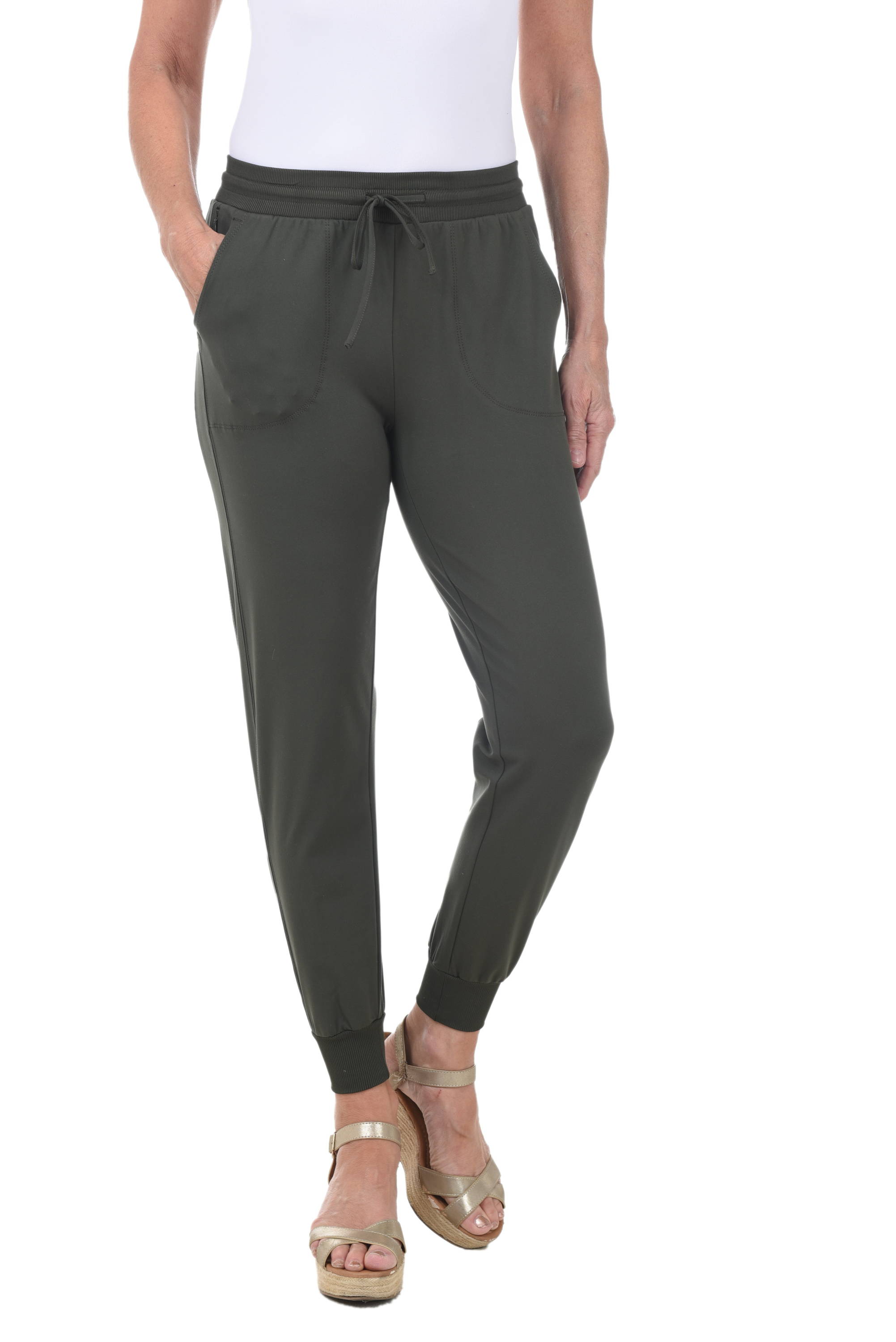 A woman wears an olive green jogger pant against a white background