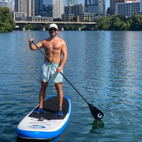Boy paddleboard with cheap inflatable paddle board in Québec lake
