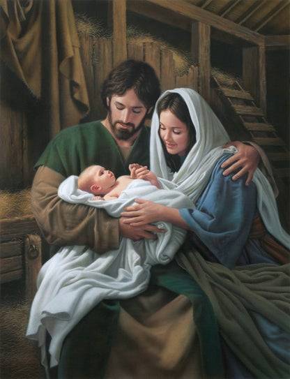 Mary and Joseph holding baby Jesus, huddled close together.