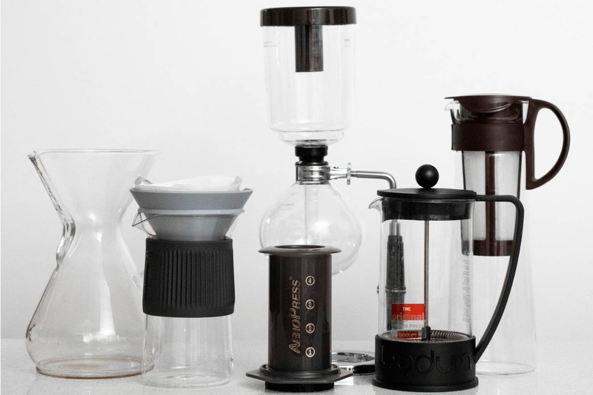 At-home brewing instruments, including an Aeropress, several pour over machines, and a French press. 