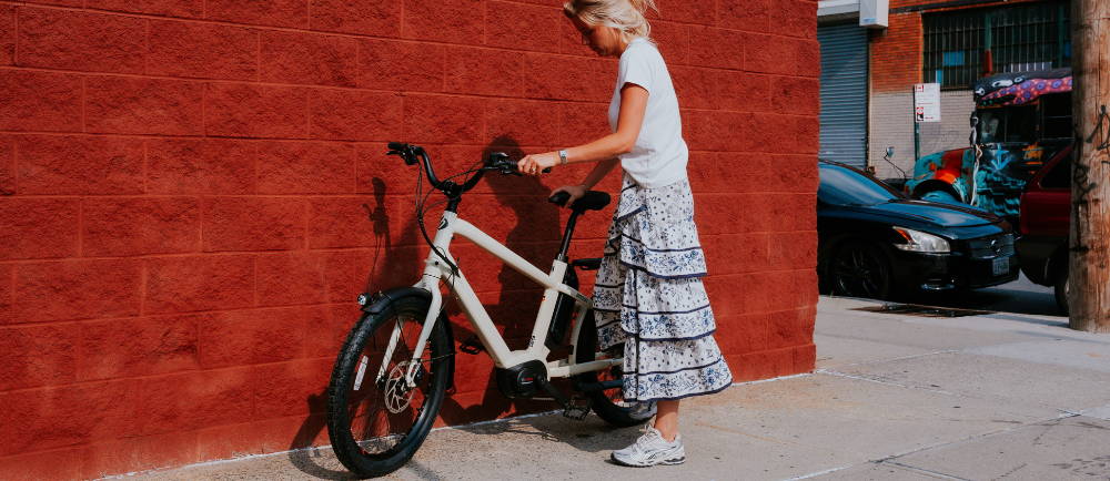 Woman with Benno Boost electric bike on sidewalk