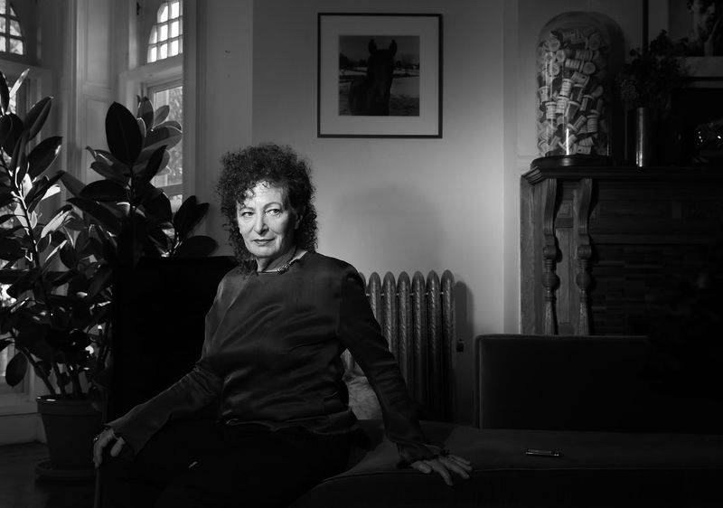 Image may contain: Nan Goldin, Face, Head, Person, Photography, Portrait, Body Part, Finger, Hand, Adult, and Couch
