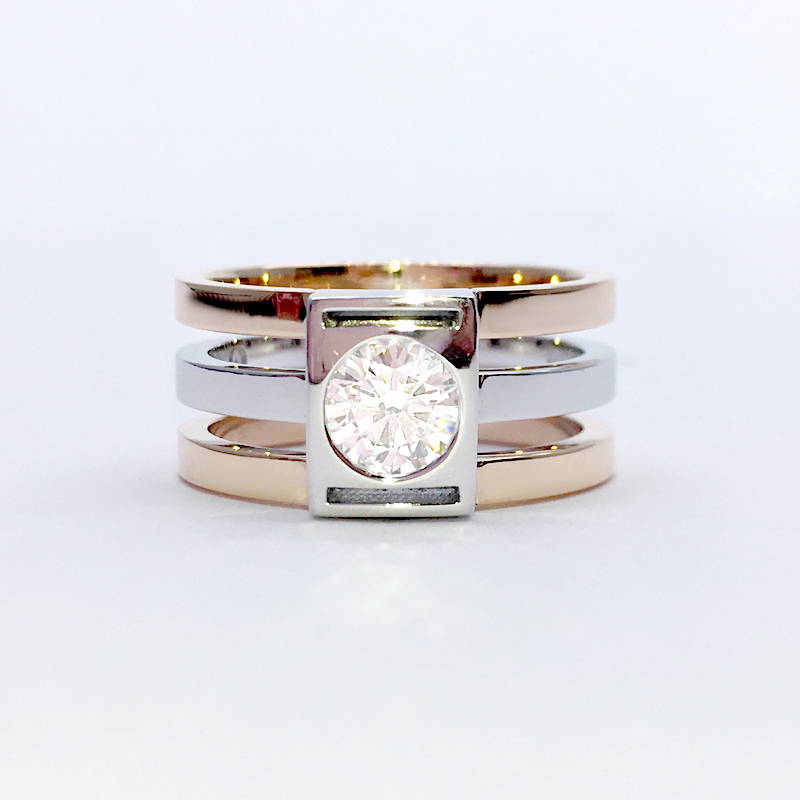 two-tone ring with three separate rings set with a large diamond