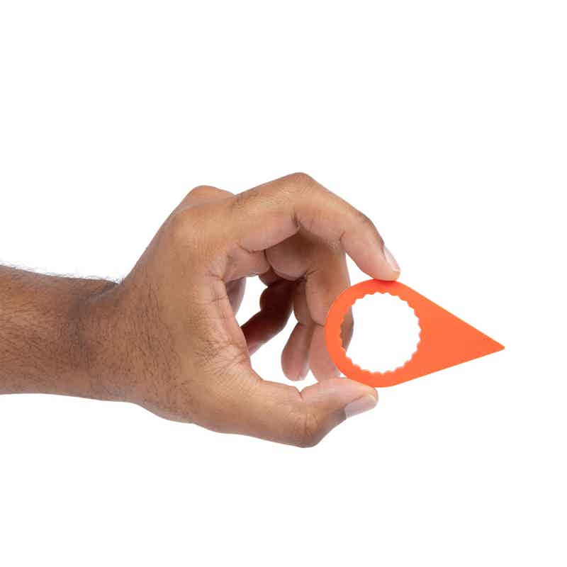 Alt Tag: Hand holding 33mm orange Torque-Tight lug nut indicator