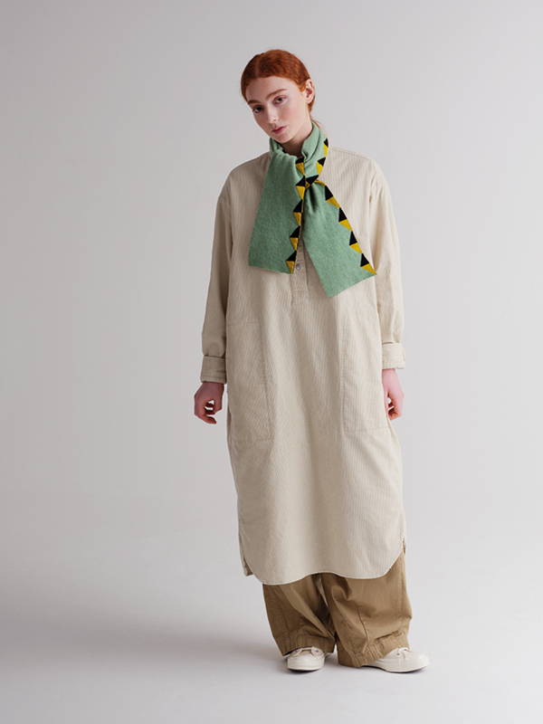 model wears small triangle edge scarf sage