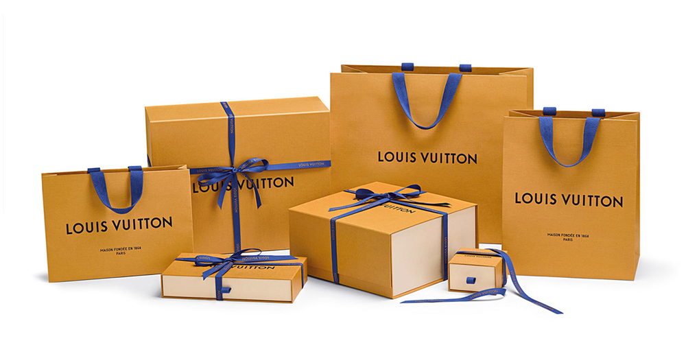 LOUIS VUITTON packaging set including two paper shopping…