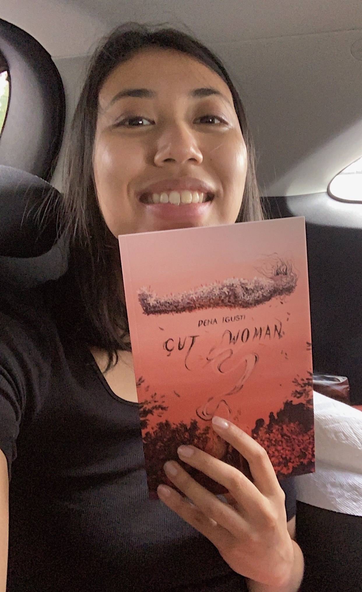 Dena Igusti with her book entitled Cut Woman