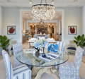 Image is the white driftwood dining table with slipcovered chairs in blue and white.