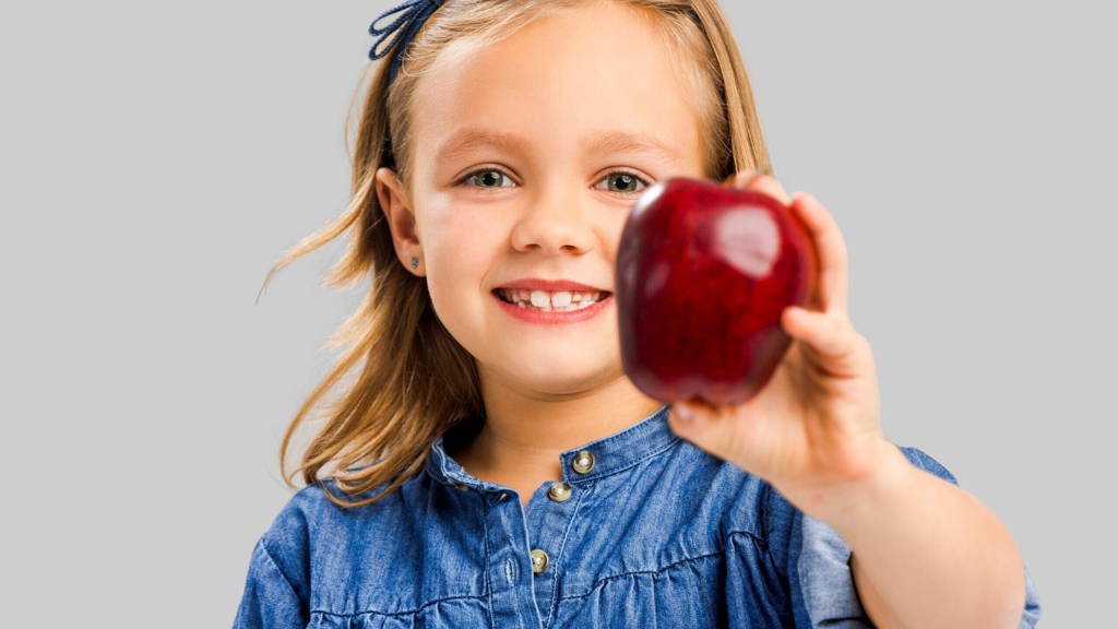 Cute girl holding an apple