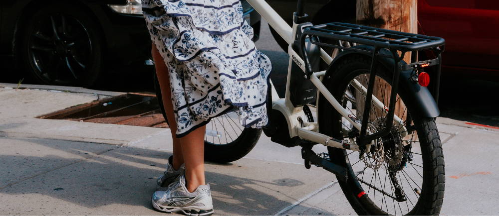 Woman with Benno Boost electric bike on sidewalk