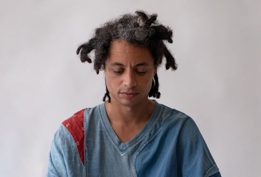 José James gazes downwards.