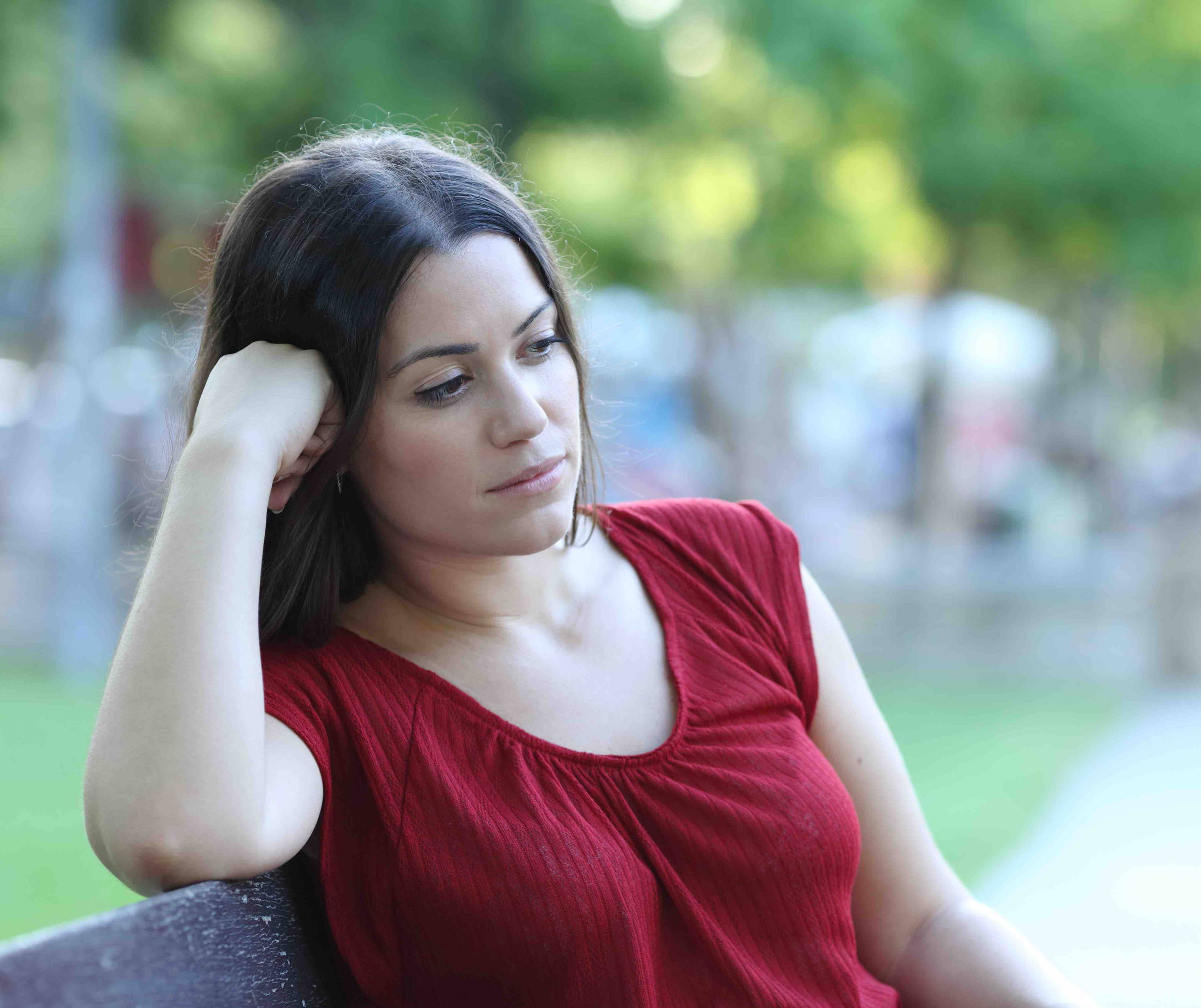  Woman on bench looking pensive