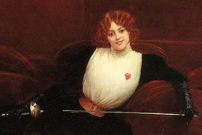 Julie D’Aubigny lying on a couch smiling with her fencing outfit and sword, looking in front of her.