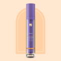 European Wax Center Brightening Ingrown Hair Serum against orange background with darker orange rectangle rounded at the top in the center