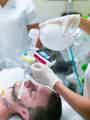 EOlife clinical device being used in hospital connected to BVM and oxygen for patient treatment.