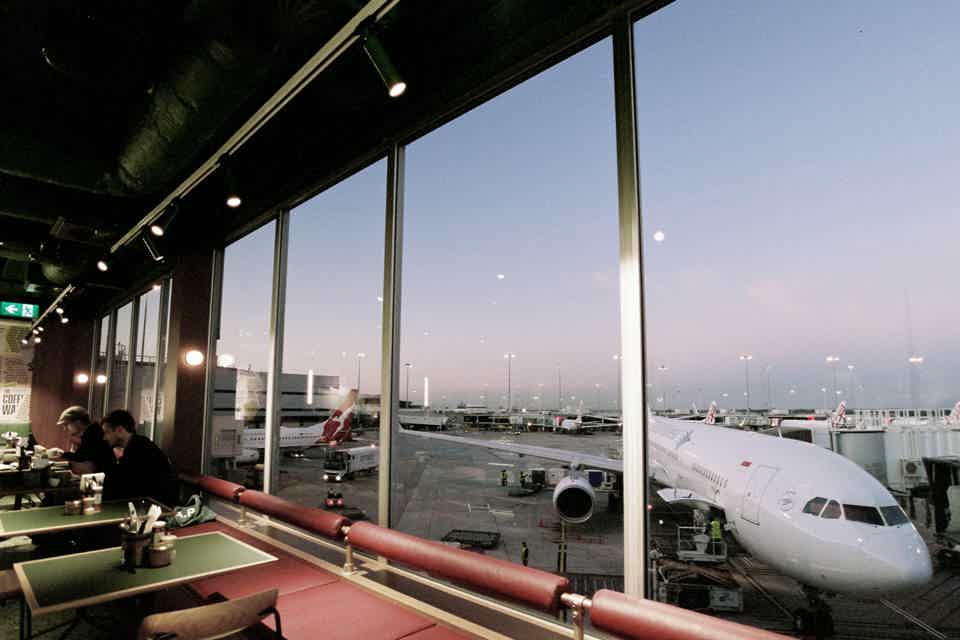 Cafe interior with aeroplane outside window at an airport