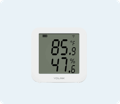 White sensor with the temperature and humidity showing in the display along with YoLink logo on the bottom of the sensor.