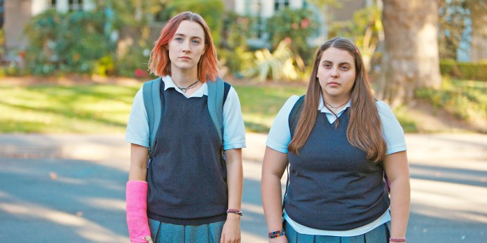 Ladybird standing with Julie both wearing their school uniforms looking to someone off camera.