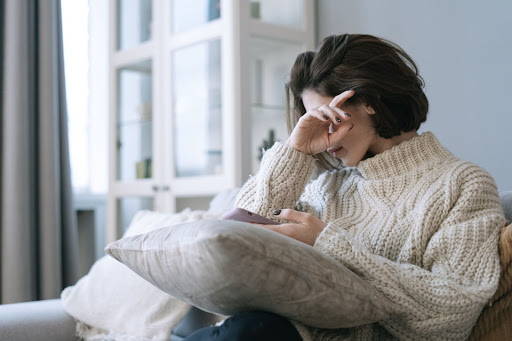 Woman on the couch, wiping her tears - Photo by Ivan Samkov from Pexels