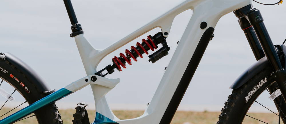 a white Cannondale Moterra full suspension electric mountain bike