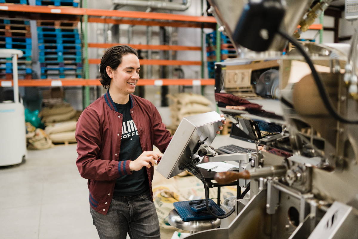 A man operating the Loring roaster, alt shot.