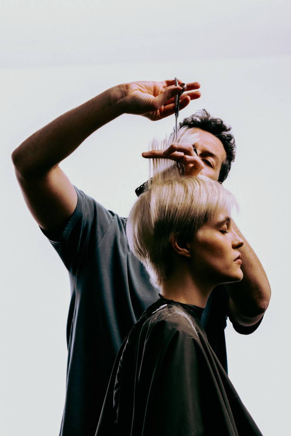 elderly woman combing her long silver hair