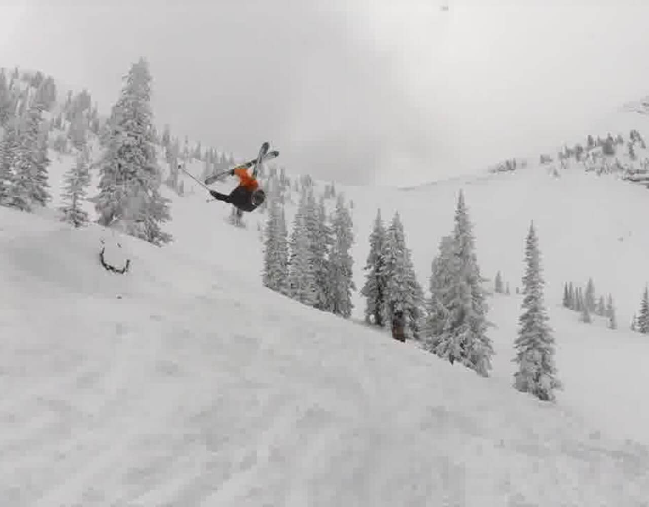 Landon on skies doing a trick on a slope