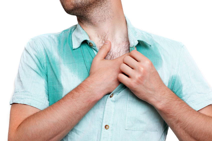Man trying to stop excessive sweating through shirt