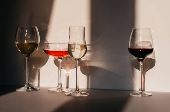 A variation of four different wine glasses; red, rosé, white, sparkling wine glasses dipslaying the importance of shape and size.