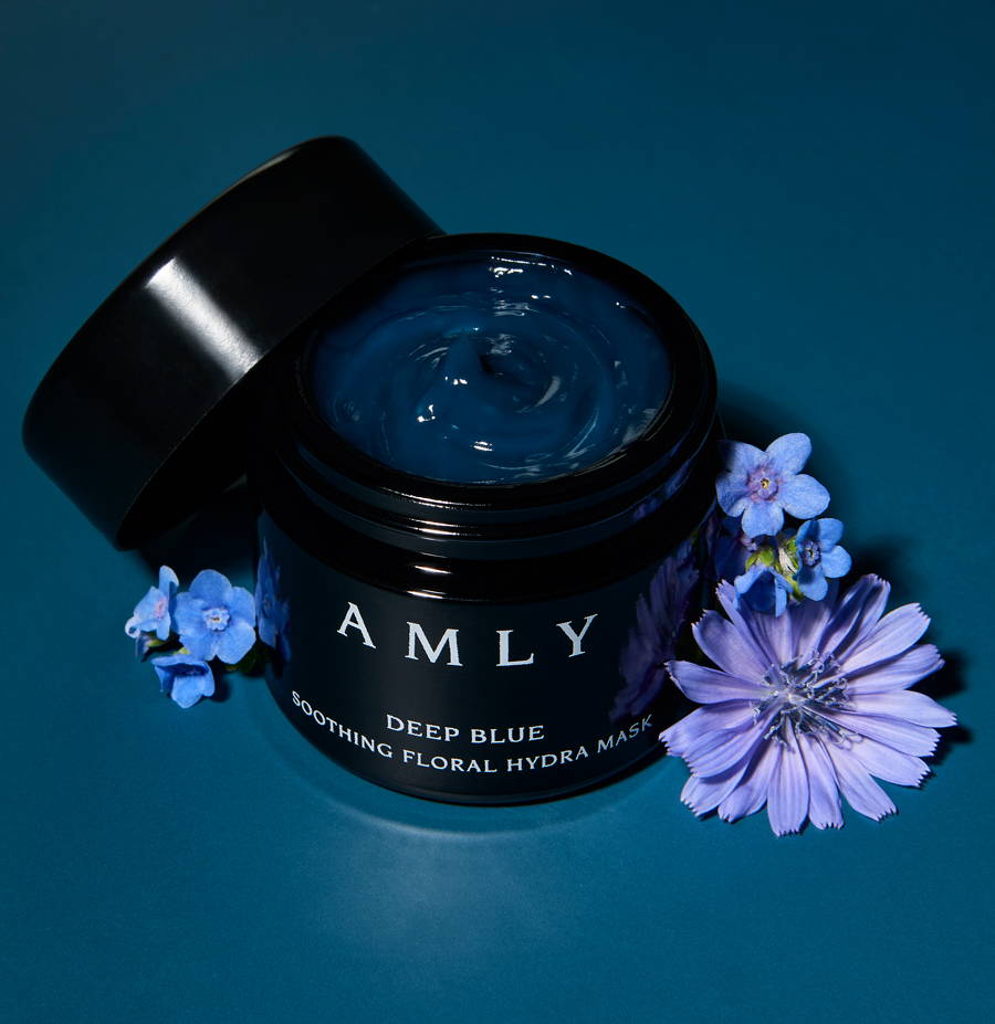 AMLY Deep Blue on a blue background with blue and purple flowers