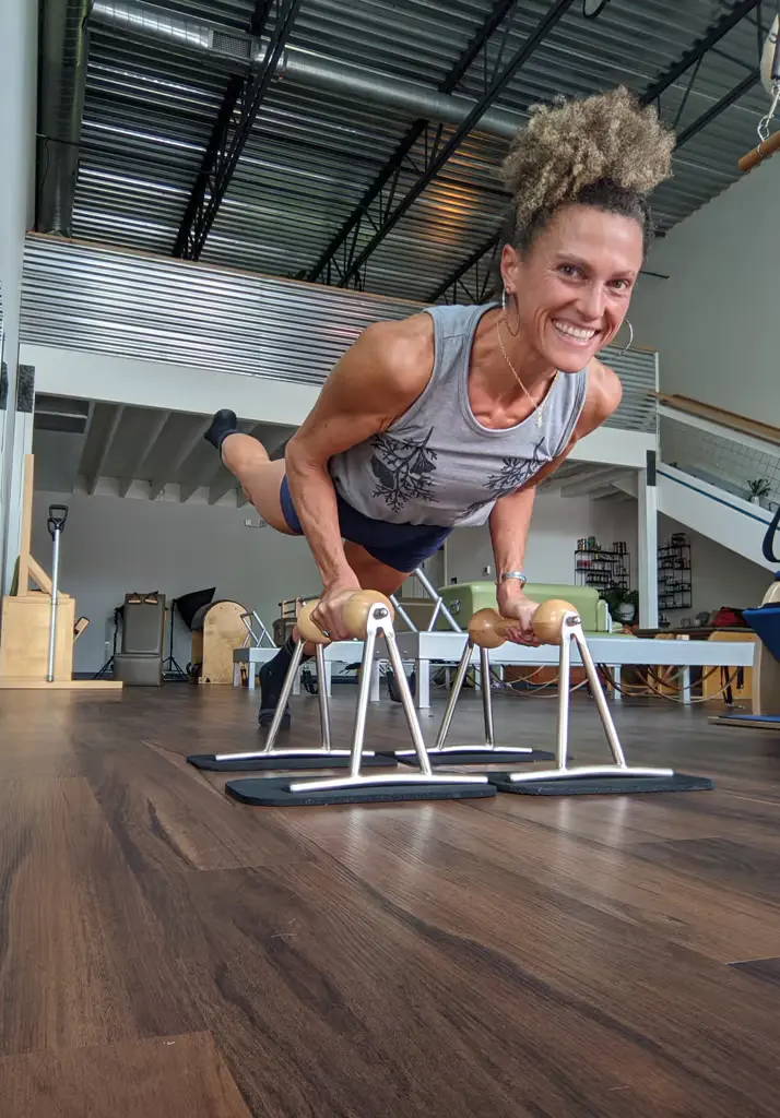 Brooke smiling while exercising on the push-up device 