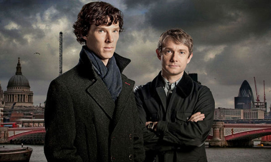 Sherlock and Watson standing side by side waring trench coeats and with serious looks.